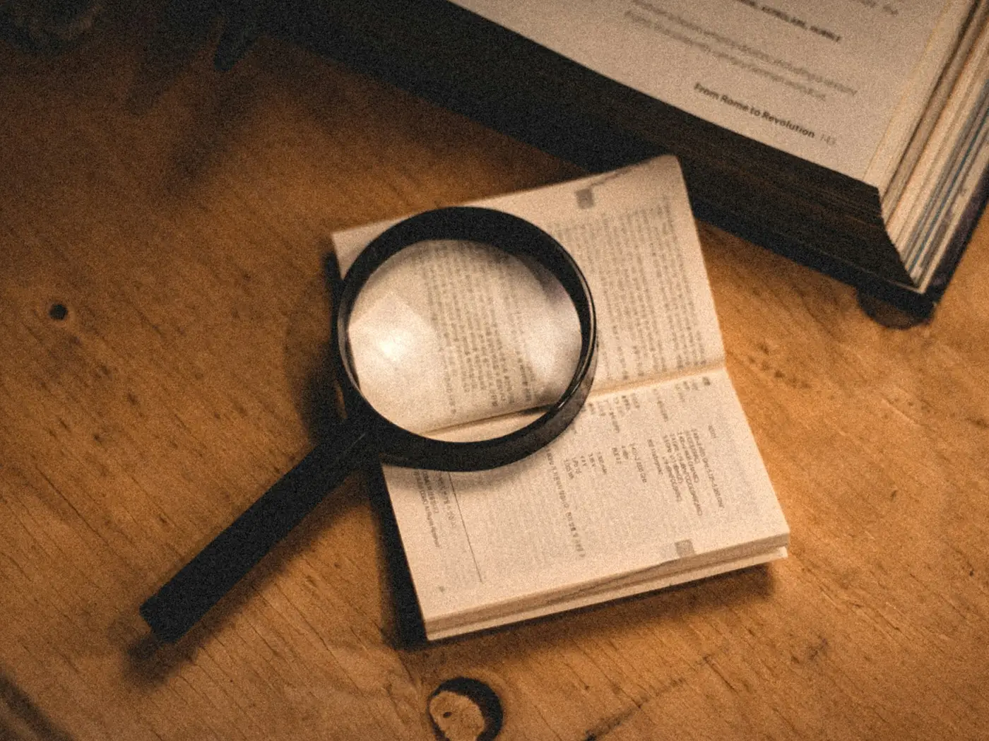 A magnifying glass resting on an open book